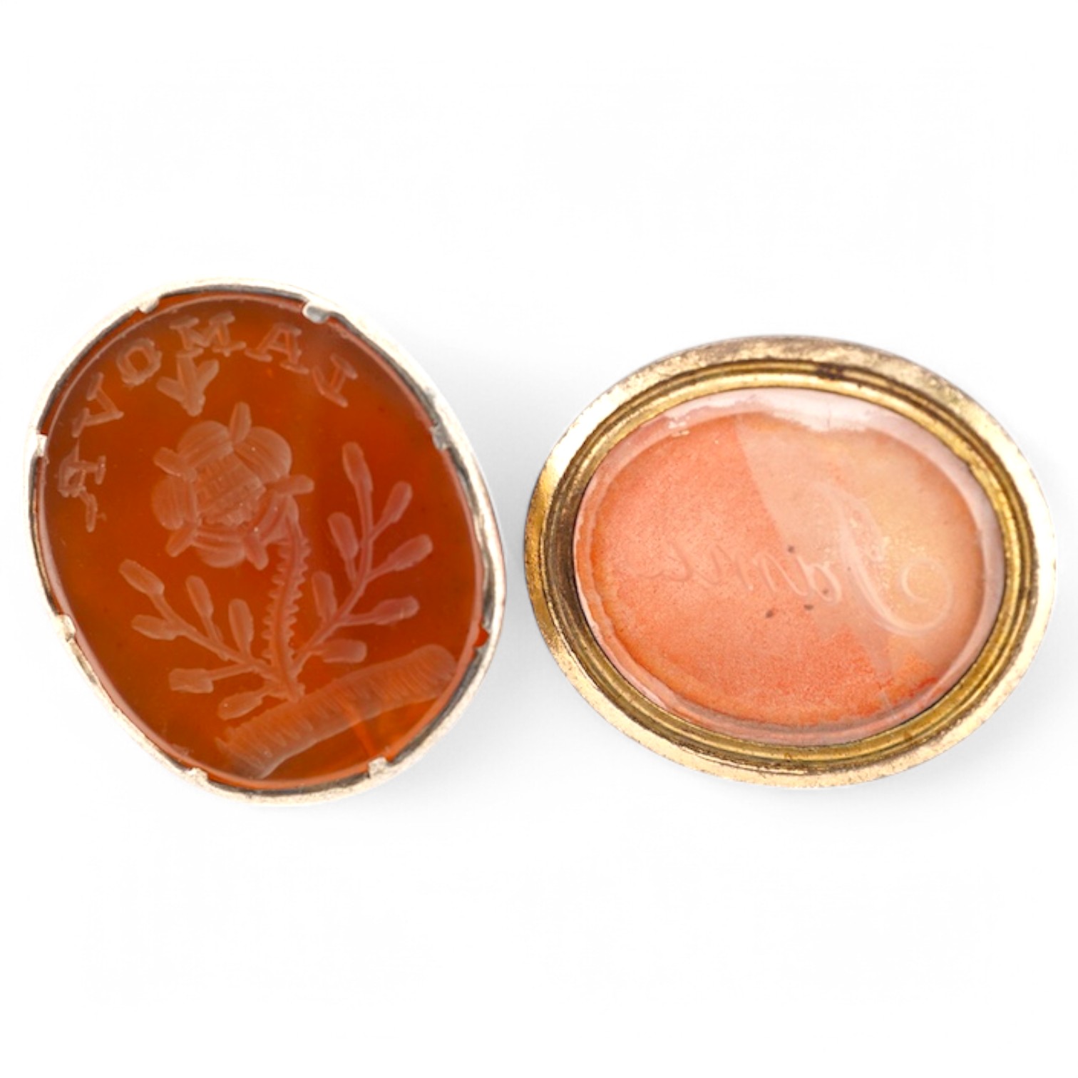 Two antique gilt metal and carnelian set fob seals, one matrix carved with the name 'James', the other 'Lamova' with a rose, 27mm et infra. Condition - poor to fair